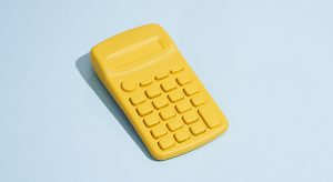 Yellow Calculator On Blue Background