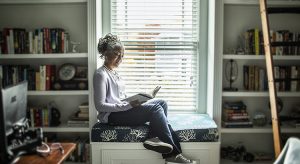 Senior woman reading in home library